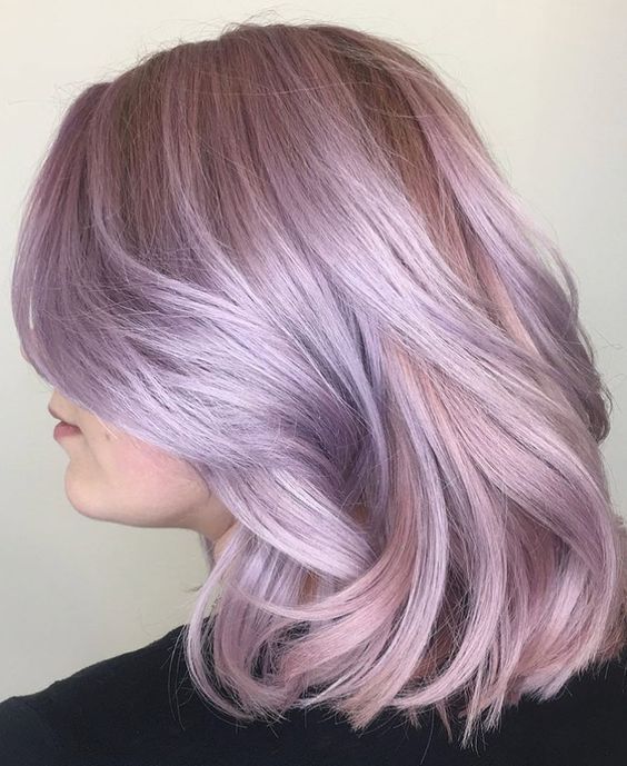 A subtle and chic lilac rose long bob with waves and face framing layers is very beautiful