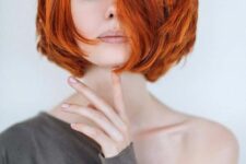 a super bright layered copper red midi bob with a lot of dimension is a cool and bold idea to rock