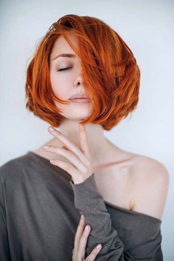 a super bright layered copper red midi bob with a lot of dimension is a cool and bold idea to rock