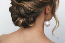 a twisted low bun with a bump on top and some face-framing waves is a cool idea for a bride