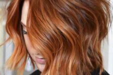 a wavy copper red long bob with a bit of orange balayage to make it brighter and catchier is a great idea
