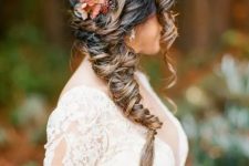 a woven twisted side braid accented with a bloom and waves framing the face is amazing for a fall wedding