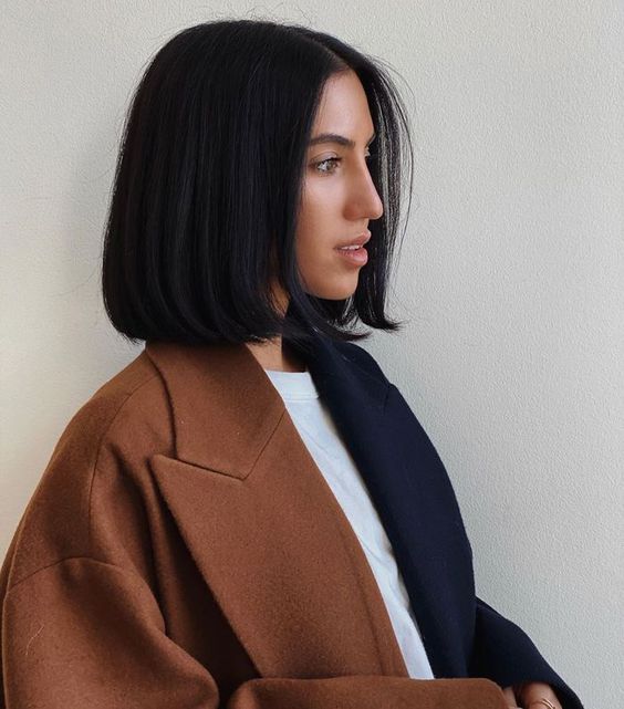 an elegant black blunt bob with middle part and curved ends is a stylish and timeless solution, with which you can never go wrong