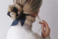 an elegant low bun interwoven with a black ribbon is a very chic idea, suitable for many styles