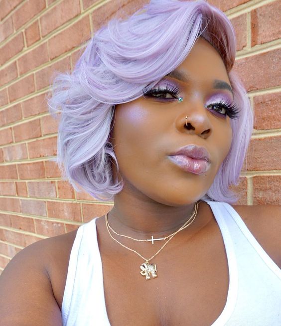 An extra bold lilac chin length bob with waves and a lot of volume looks jaw dropping
