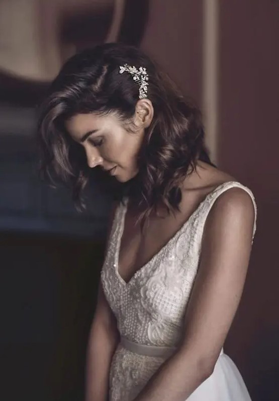 Medium hair can be styled in waves, as a side swept hairstyle with a rhinestone hairpiece, it's great for a chic bride