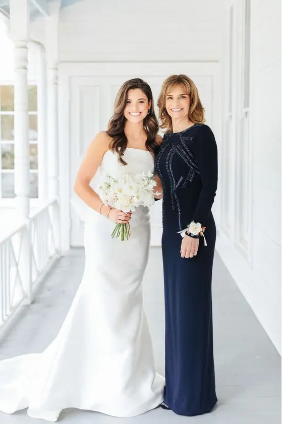a gorgeous navy fitting maxi dress with embellishments, a high neckline and long sleeves is pure elegance and chic