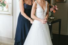 16 a navy maxi dress with an embellished neckline, straps, a tiered skirt is a stylish and chic idea for the mother of the bride