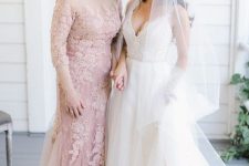 22 a blush lace fitting maxi dress with an illusion neckline, short sleeves and a train for a formal and chic look