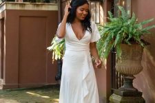 26 a white maxi dress with a deep neckline and a ruffle skirt plus short sleeves is a great bridal shower solution