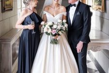 32 a black midi dress with a halter neckline, a ruffle detail and a pleated skirt plus spaghetti straps is a stylish idea for a mother of the bride