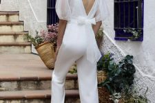 41 a plain white jumpsuit plus a sheer organza top with puff sleeves and a bow are a cool combo for a bridal shower or a wedding