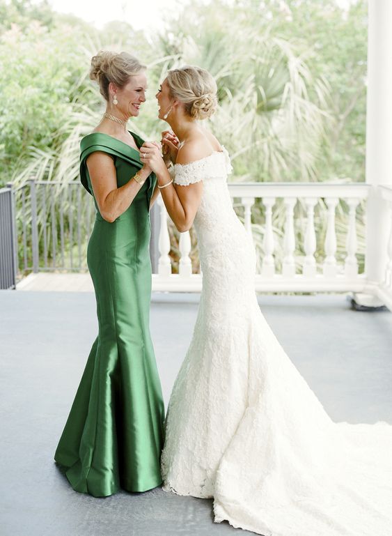 a green mermaid maxi dress with a V-neckline and some statement jewelry are a great combo for a mother of the bride