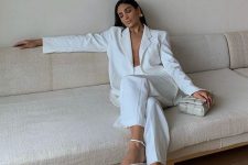 45 a white pantsuit with wideleg pants, strappy shoes and a woven bag are a super edgy combo for a bridal shower