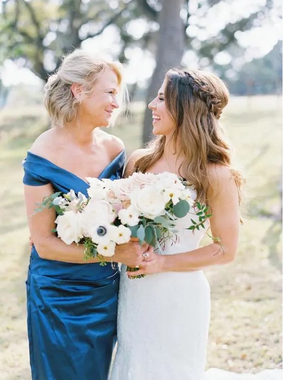 a luxurious navy off the shoulder draped midi dress is a stylish and refined option for a mother of the bride