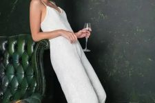a white sequin jumpsuit with spaghetti straps, a V-neckline and straight leg pants plus white shoes for a trendy and shiny outfit