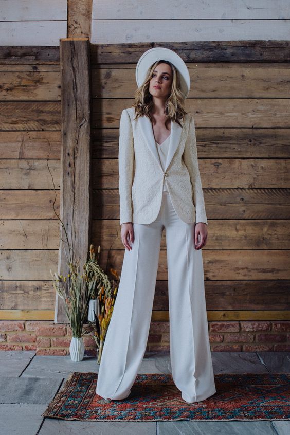 a corset top, wideleg pants, a neutral patterned blazer and a hat are a lovely look for a bride shower