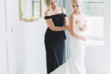 59 an elegant black fitting off the shoulder dress with an oversized bow is very chic and bold for a mother of the bride