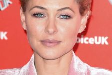 Emma Willis wearing a brushed back blonde long pixie that adds a punk feel to her look and helps express the personality
