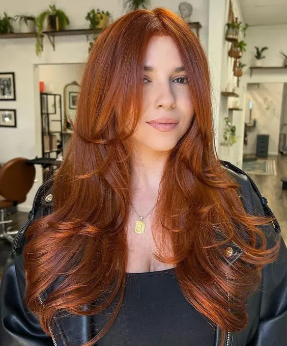 a beautiful and elegant copper long butterfly haircut with face-framing layers and curled ends is a lovely idea