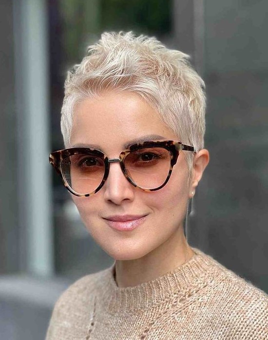 a beautiful creamy blonde pixie cut with styling on the top looks bold, chic and cool