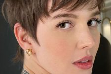 a beautiful layered long brunette pixie haircut with bangs and volume is a chic and stylish idea to rock