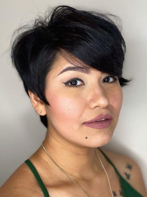 a beautiful long pixie haircut with a side fringe and a lot of volume looks spectacular and very chic and cool