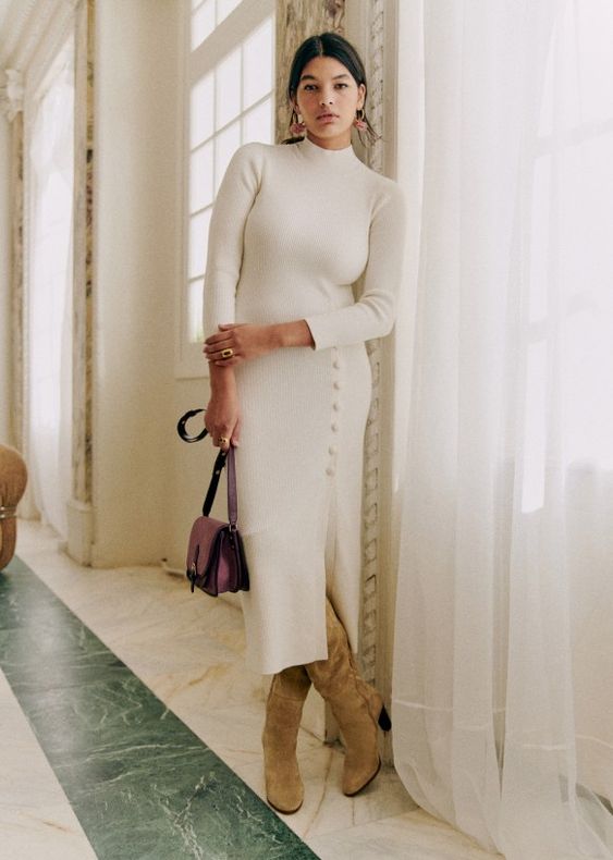 a beautiful midi sweater dress with a row of buttons and a slit, tan boots and a purple bag for a winter bridal shower