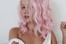 a beautiful shoulder-length bubblegum pink wavy hairstyle with much volume is an amazing idea