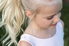 a beautiful wavy high ponytail with braids on top and a bit of mess is a lovely idea for a rustic, casual or boho flower girl look