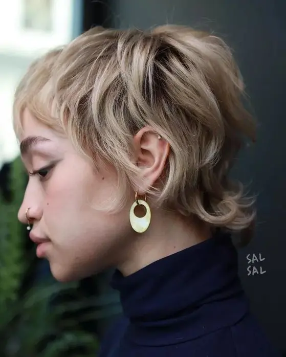 a blonde layered pixie with natural curls and a texture, with darker root and long sides and fringe is a very chic idea