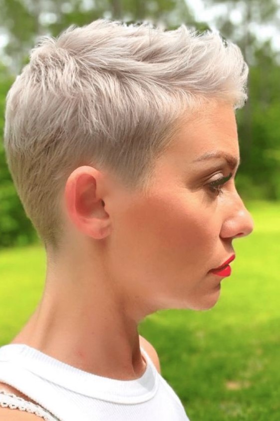 a blonde short pixie haircut with side parting and a bit of styling is an easy to maintain hairstyle that wows