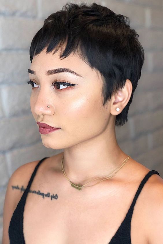 a bold black pixie cut with wispy bangs and a bit of messy waves is a lovely idea, it looks casual and very up-to-date