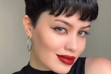 a bold black pixie haircut with a classic fringe and a lot of volume, shorter on the sides, is a lovely idea to rock