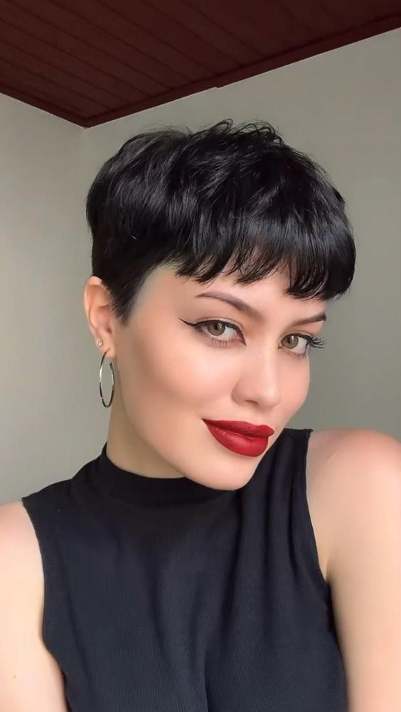 a bold black pixie haircut with a classic fringe and a lot of volume, shorter on the sides, is a lovely idea to rock
