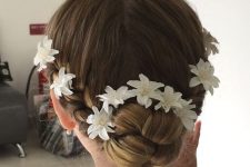 a braided top knot and some fabric blooms tucked into the hair is a lovely and chic idea for a flower girl