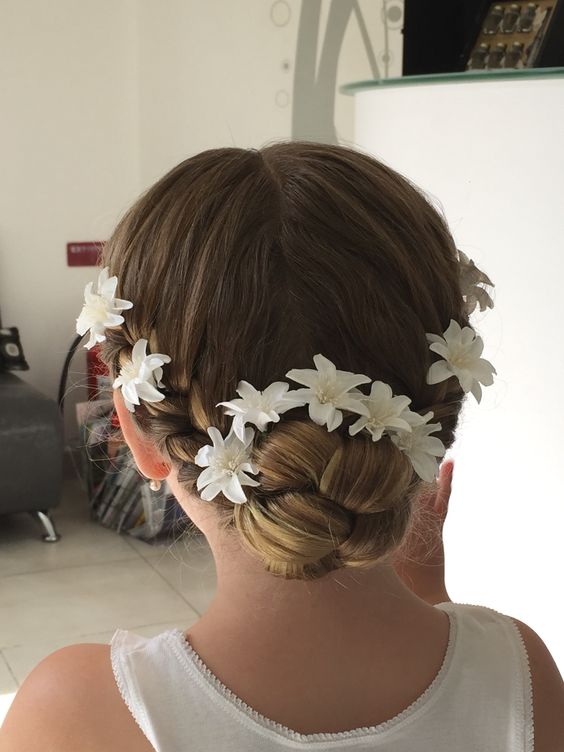 a braided top knot and some fabric blooms tucked into the hair is a lovely and chic idea for a flower girl