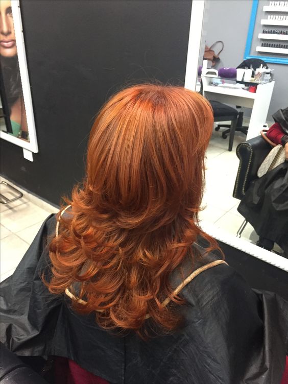 a bright and catchy copper butterfly haircut with curled ends and a lot of volume is a cool and chic solution