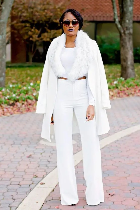 A chic and glam all white look with wide leg pants, a crop top, faux fur and a jacket is lovely for a winter bridal shower