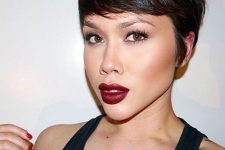 a chic and shiny black pixie haircut with long side bangs and texture is amazing, it looks absolutely cool