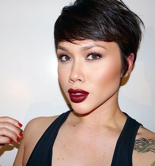 a chic and shiny black pixie haircut with long side bangs and texture is amazing, it looks absolutely cool