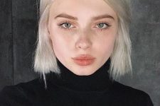 a chin-length platinum blonde bob with a darker root and some volume is a bold solution that wows
