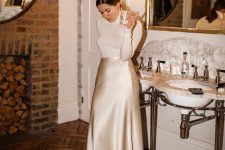 a classyc winter bridal shower look with a white turtleneck, a silk slip midi skirt, add shoes and accessories and go