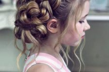 a complicated braided low updo with locks down is a great idea for a flower girl with very long hair