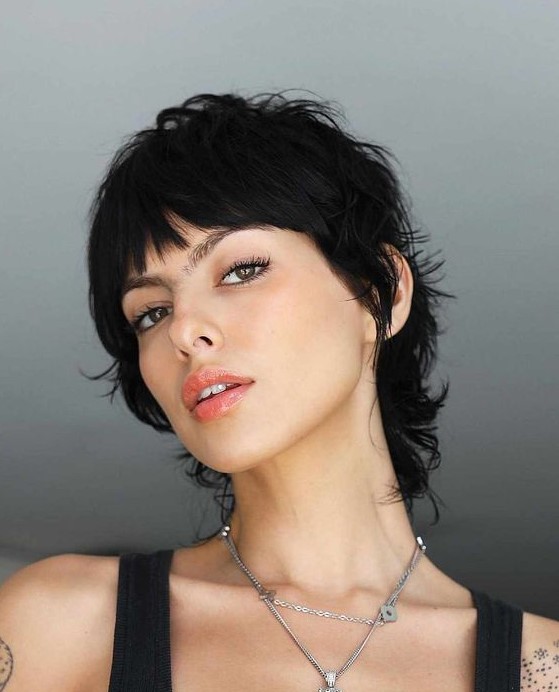 a cool short black mullet with bangs, waves and a lot of dimension is a bold and super sexy solution