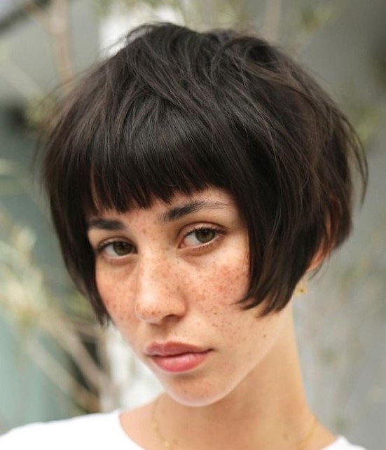 A dark brunette ear length bob with a classic fringe and a messy volume is a cool solution and this hair is easy to style