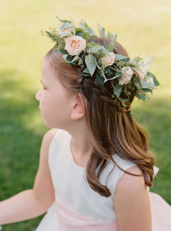 a half updo with a briaded halo and waves down plus a fresh flower crown is a cool idea