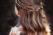 a half updo with a triple braided halo and waves down is a chic and cool idea for a flower girl with long hair