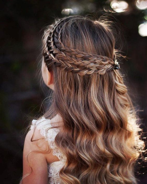 a half updo with a triple braided halo and waves down is a chic and cool idea for a flower girl with long hair