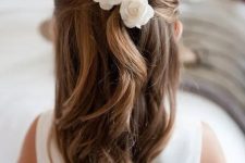 a half updo with twists and waves down, with white silk blooms will match a classic and formal flower girl look